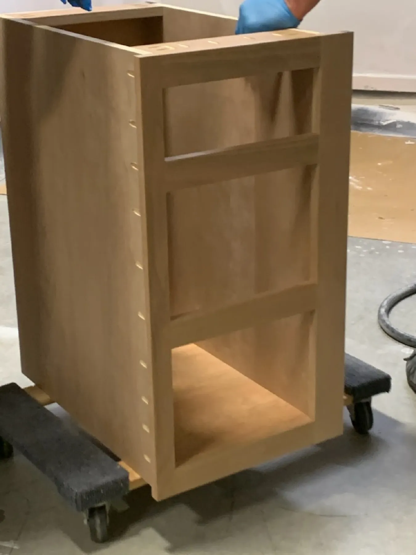 Primed cabinet frame on a dolly ready for finishing